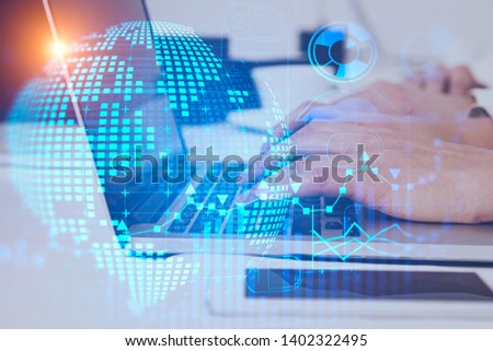 Man hands typing on tablet computer in office with double exposure of global business infographics hologram. Concept of market analysis and fintech. Toned image