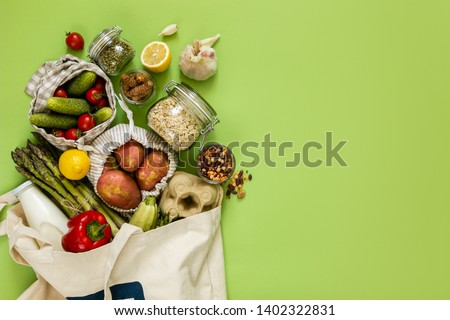 Zero waste shopping concept - groceries in textile bags and glass jars, top view Royalty-Free Stock Photo #1402322831