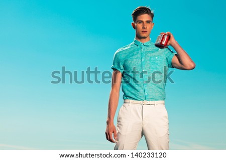 Retro fifties summer fashion man in blue shirt listens to portable radio. Outdoor. Blue sky. Royalty-Free Stock Photo #140233120