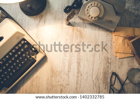 typewriter with phone and letters on desk