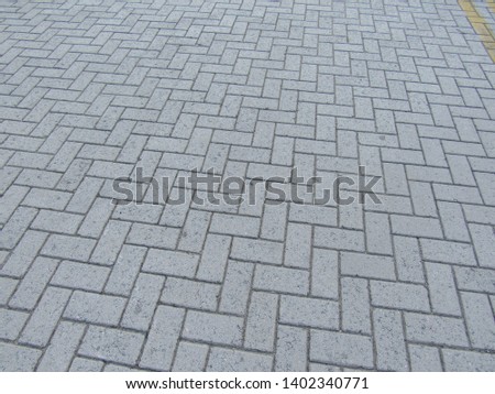 Detail of pavement blocks texture and a yellow line