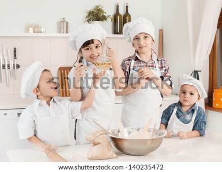 happy little chefs preparing dough in the kitchen