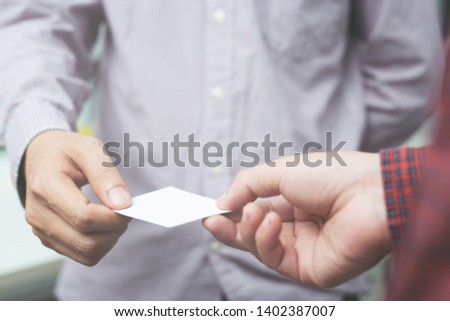 business man in hand hold show business cards blank empty white card mock up filing give to connect Partner contacts on the desk in office. Business branding Successfully connected in business concept