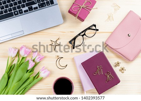 Woman office desk with notebooks, laptop, decor and accessories, top view, copy space