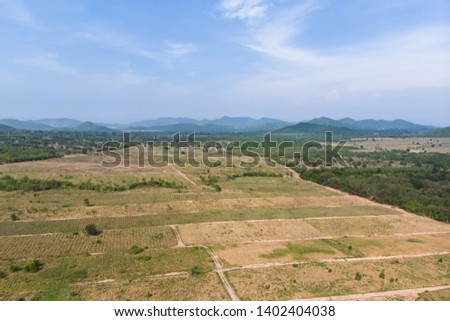 Drone shot aerial view scenic landscape of agriculture farm against mountain and nature forest