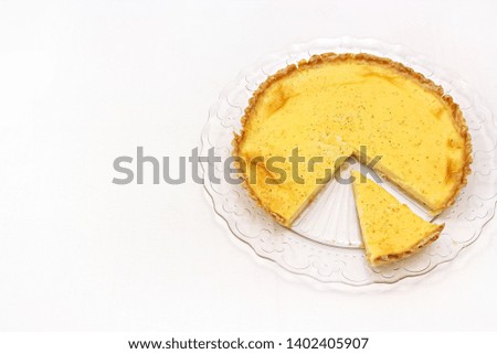 Sweet custard tart or lemon pie white background. Selective focus. Close up. Copy space.