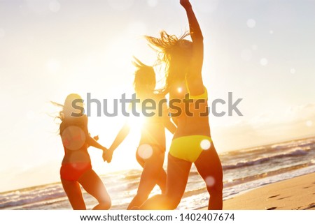 young girls enjoying the sun, sand and sea
