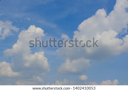Beautiful bright blue sky with white fluffy clouds on a clear sunny day. Royalty high-quality free stock photo of blue sky with white cloud. Photo of natural cloudscape background