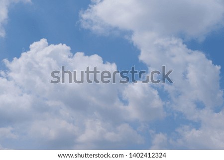 Beautiful bright blue sky with white fluffy clouds on a clear sunny day. Royalty high-quality free stock photo of blue sky with white cloud. Photo of natural cloudscape background