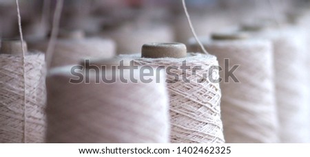 Close up Row of textile threads industry . Royalty-Free Stock Photo #1402462325