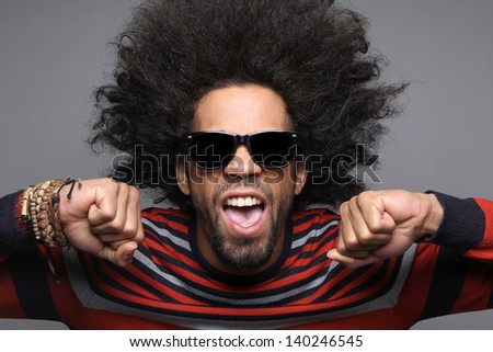 Cool man with an afro and sunglasses poses