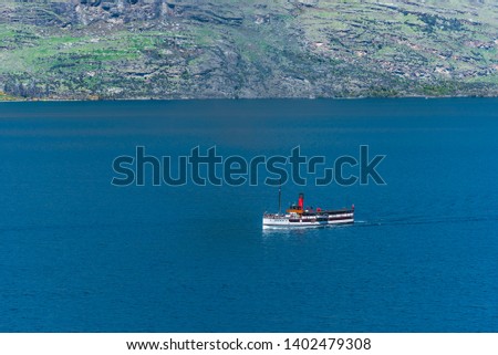 Steamboat sails on lake Wakatipu, Queenstown, New Zealand. Copy space for text                                                 