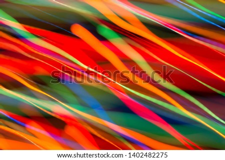 Abstract image of bright colored dynamic lights on a dark background
