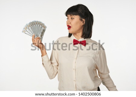   Business woman with money on bright background                            