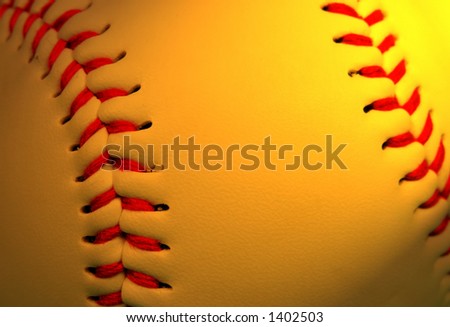 Extreme close up of a baseball in special lighting condition with selective focus on the left part.