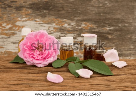 Damask rose or Rose, flowers on old wooden background.(Perfume)