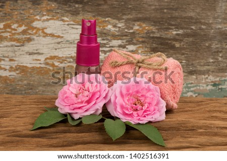 Damask rose or Rose, flowers on old wooden background.(Spray rose water)