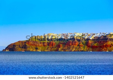 Santorini island, Greece panorama of Oia village on volcanic rocks with colorful houses and blue sky