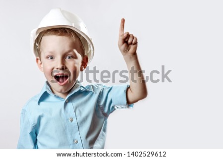 the boy in the light blue shirt and construction helmet of the foreman raised a finger, as if he had found the idea