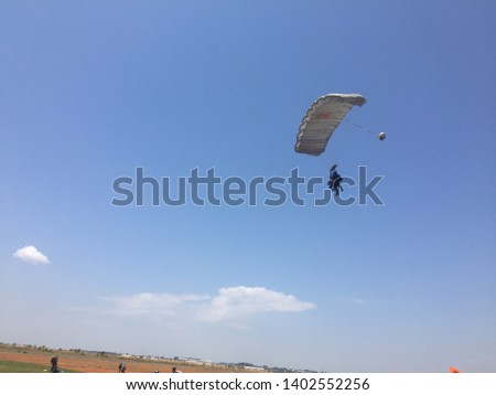 Paragliding, idealized of a mixture of hang gliding and parachute, paragliding in free flight, recreation, competition, training, dynamic flight, radical sport, work, military training, very blue sky.