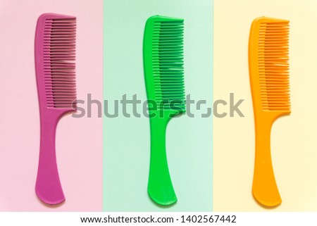 Comb icon. Pink, green, yellow icon isolated on Pink, green, yellow background 