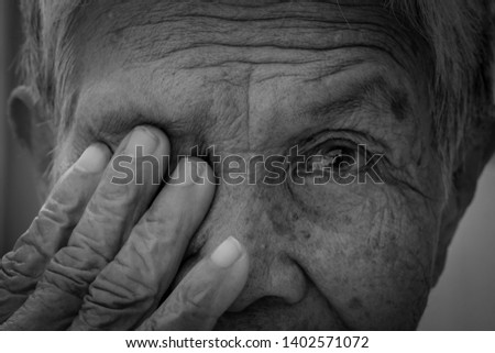 Old women cover her eye with her hand for eye testing use for medical and healthcare background Royalty-Free Stock Photo #1402571072