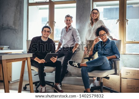 Portrait of successful group of people working at online web store. Men and women at ecommerce business office. Royalty-Free Stock Photo #1402579832
