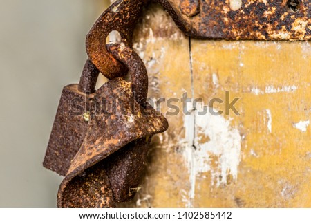 Rusted lock hanging on a door in an abandoned old farm in Belarus, Chernobyl exclusion zone