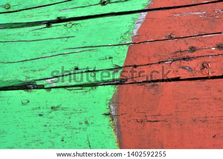 antique wood with chipped green and red paint