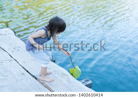 Cute boy on wooden jetty