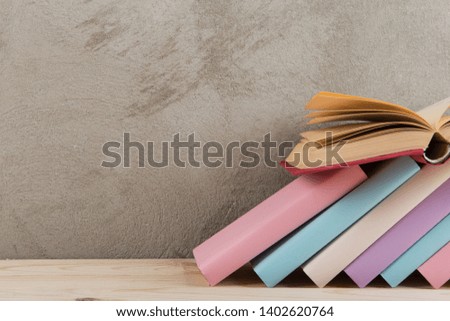 Education and reading concept - group of colorful books on the wooden table