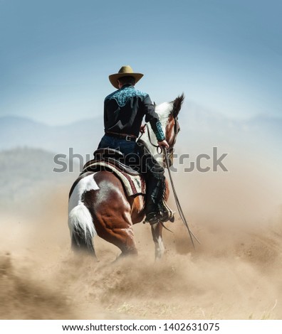 cowboy on a horse running in desert