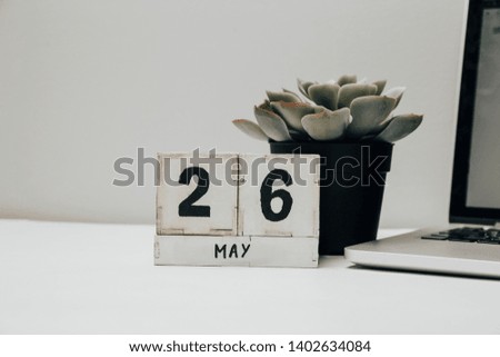White wooden calendar with black 26 may