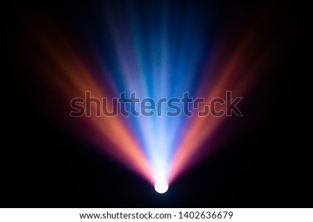 beautiful multicolor spotlight wide lens projector with light beam for film movie and cinema at night . abstract smoke texture . screening for multimedia with black background .