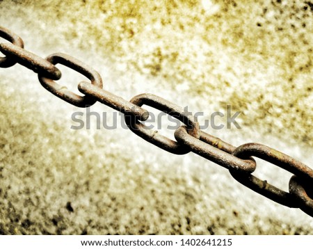 The old chain has rust-up some dark brown background images are cement rough, the image is decorated to a pale brown tone.