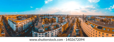 Aerial panorama view of wide city streets in receding perspective at sunset in golden light with a glow in the sky over the distant horizon