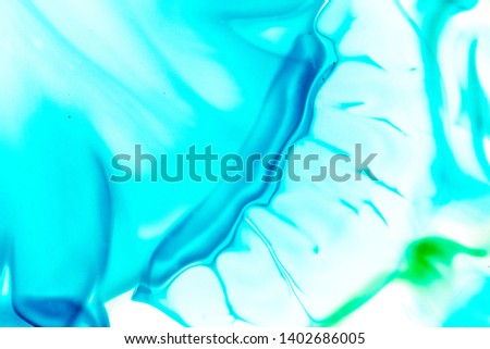 Colorful Abstract Background, mix color paint: blue, turquoise, green, brown, white background. Technique: Acrylic fluid and watercolor. Close up image. Mixed bright abstract watercolor. Macro photo