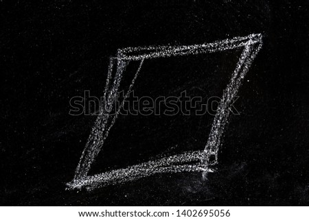 Geometric shapes of chalk lines on a chalkboard, a square or a rhombus