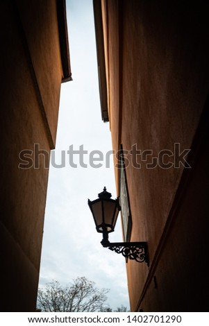 Photo of a old facade in the historical centre of Erfurt. An old lamp is in the middle of the picture.