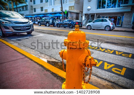 Yellow hydrant on the edge of the road on Ocean Drive, Miami Beach. Southern Florida, USA