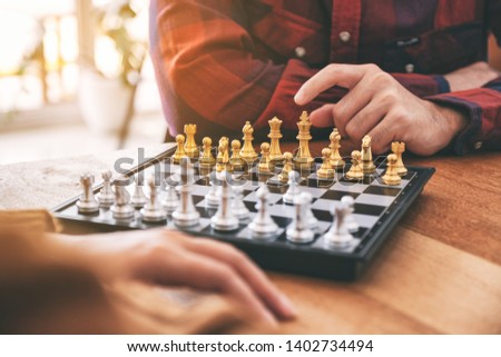 Closeup image of people moving and playing chessboard game together