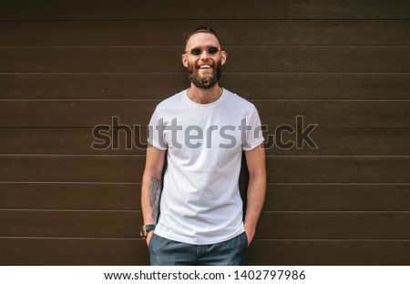 Handsome hipster model wearing white blank t-shirt. blank space for text or logo