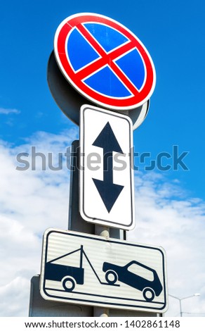 Road sign prohibiting stopping of vehicles. Traffic sign prohibiting parking. Evacuation on tow truck