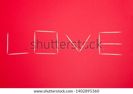 The word, Love, in toothpicks letters with red background, for Valentine, Mothers Day.