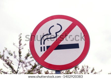 No smoking sign outdoors in the park. Cigarette, smoke, public place.