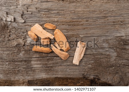 Small group of alder wood smoking chips for barbecuing on a weathered background.