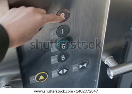 the woman touch the elevator button.