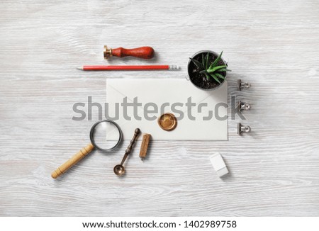 Vintage stationery and blank envelope on light wood table background. Template for graphic designers portfolios. Flat lay.
