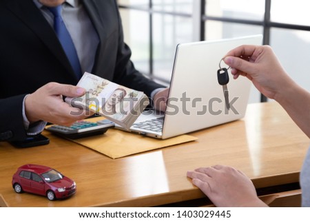 Woman hands holding keys submit to the bank, Quick loan and car loan concept