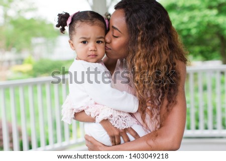 Mother holding toddler baby girl
